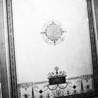 Ornate, monochrome ceiling decoration with symmetrical patterns and details.