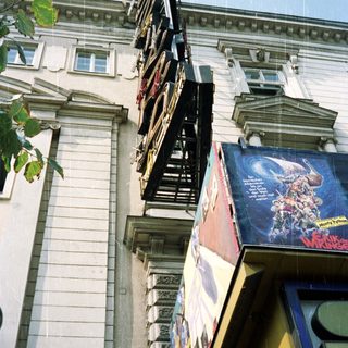Building facade with a marquee advertising a show.