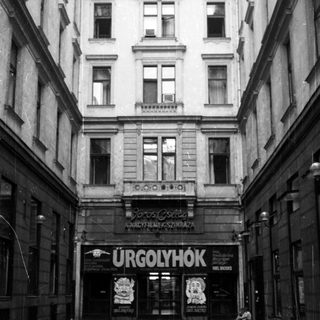 An alley leads to a theater entrance in Budapest.