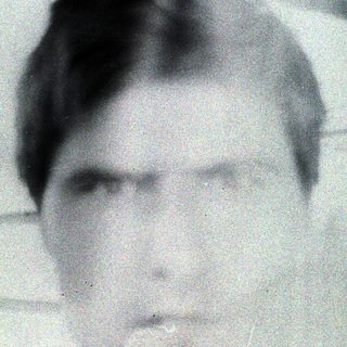 Black and white portrait of a man with short hair.