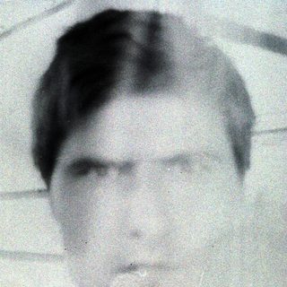 Black and white portrait of a man with short hair.