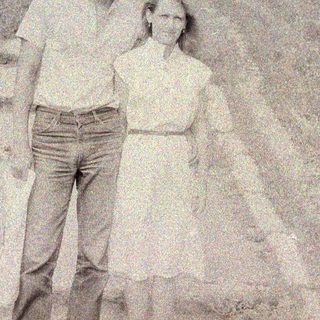 Black and white photo of a man and woman outdoors.