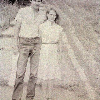 Black and white photo of a man and woman outdoors.