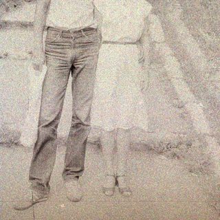 Black and white photo of a man and woman outdoors.