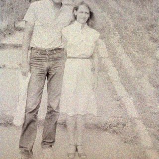 Black and white photo of a man and woman outdoors.