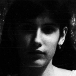 Black and white image of a woman at a table.