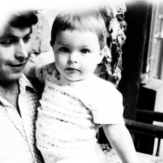 Man holds young child in a black and white photo.