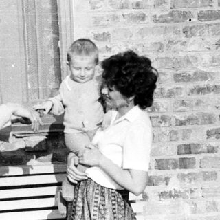 Black and white photo of people near a window.