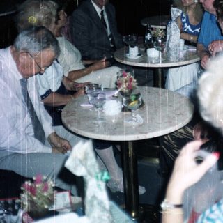 Group of people seated at a table in a restaurant.