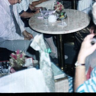 Group of people seated at a table in a restaurant.