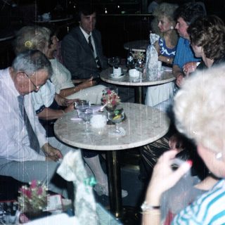 Group of people seated at a table in a restaurant.