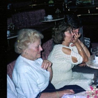 Group of people socializing at a table in a nightclub.