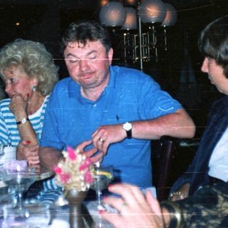 Group seated at a table in a dimly lit restaurant.