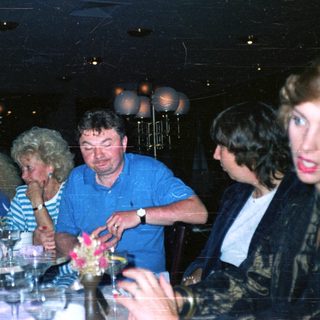 Group seated at a table in a dimly lit restaurant.