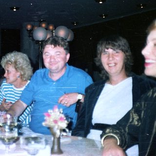 Group of people dining at a restaurant with decor.