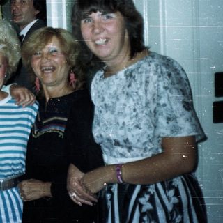 Group of people posing indoors, styled with 1980s fashion.