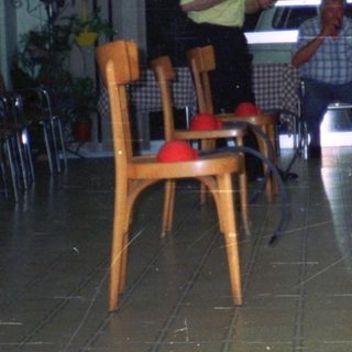 People gathered in a room, a woman serving drinks.