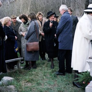 Group of people gathered outdoors near a building.