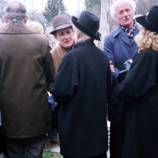 Group of people gathered outdoors, likely in a formal setting.