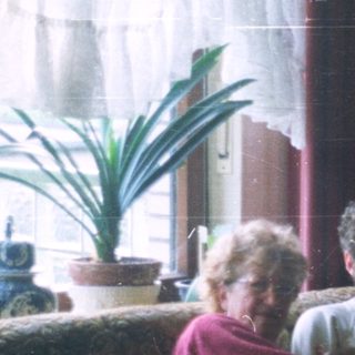 Group of people seated on a vintage sofa.