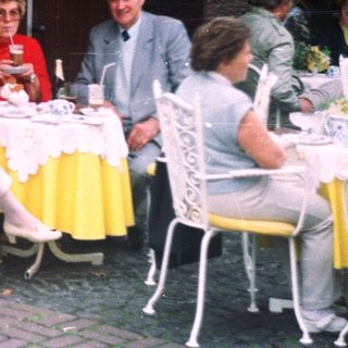 Group of people dining at an outdoor cafe.