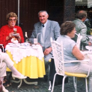 Group of people dining at an outdoor cafe.