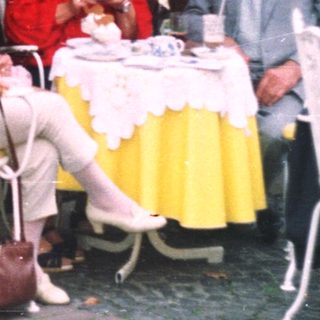 Group of people dining at an outdoor cafe.