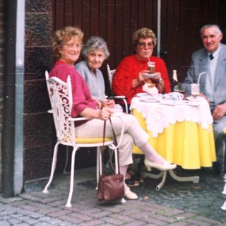 Group of people dining at an outdoor cafe.