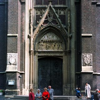 People stand before a large, ornate church entrance.