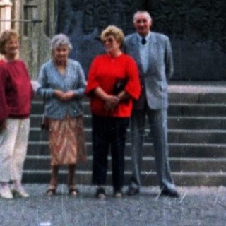 People stand before a large, ornate church entrance.