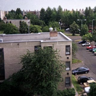 Apartment buildings and cars in a residential area.