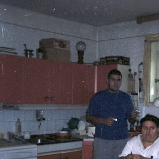 Man preparing food in a kitchen with a window.