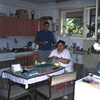 Man preparing food in a kitchen with a window.