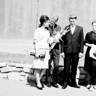 Family portrait featuring John F. Kennedy and several women and a child.