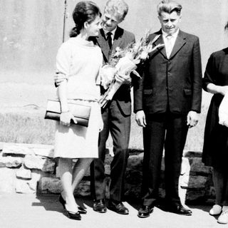 Family portrait featuring John F. Kennedy and several women and a child.