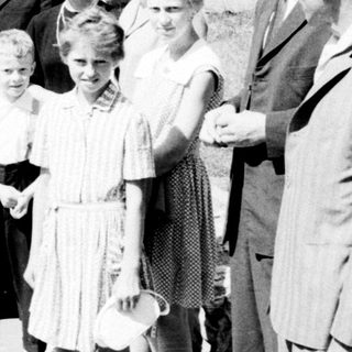Group of people standing on a street, possibly posed.