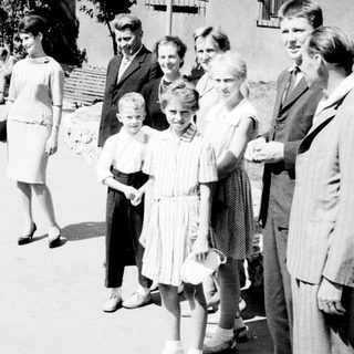 Group of people standing on a street, possibly posed.