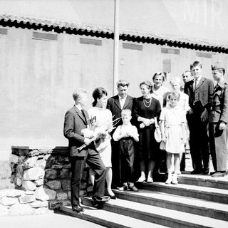 Group of people posed outdoors, likely a formal occasion.