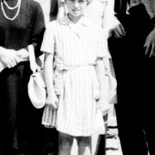 Group of people posed outdoors, likely a formal occasion.