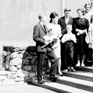 Group of people posed outdoors, likely a formal occasion.