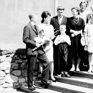 Group of people posed outdoors, likely a formal occasion.