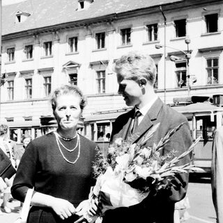 Three people posing outdoors, likely celebrating an achievement.