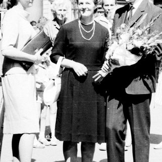 Black and white photo of a couple and well-wishers.