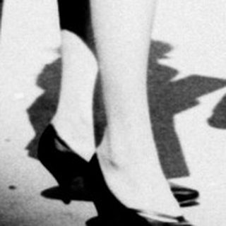 Black and white photo of a couple and well-wishers.