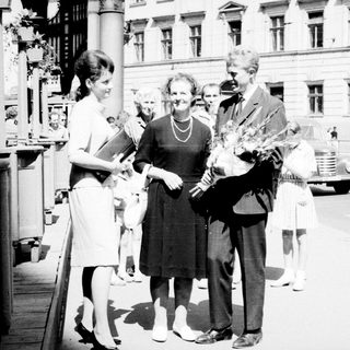 Black and white photo of a couple and well-wishers.