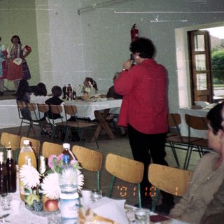 Group performance on stage with audience seated at tables.