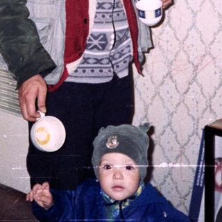 Man and woman with child inside a room.