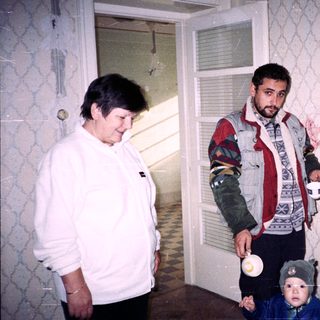 Man and woman with child inside a room.