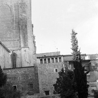 Black and white image of a church tower and buildings.