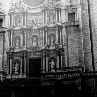 Ornate, monochrome facade of a historic building with statues.